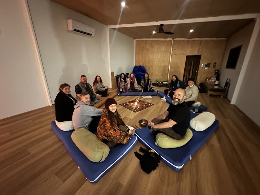 CPACT students seated together in a circle around a candlelit centrepiece during a retreat